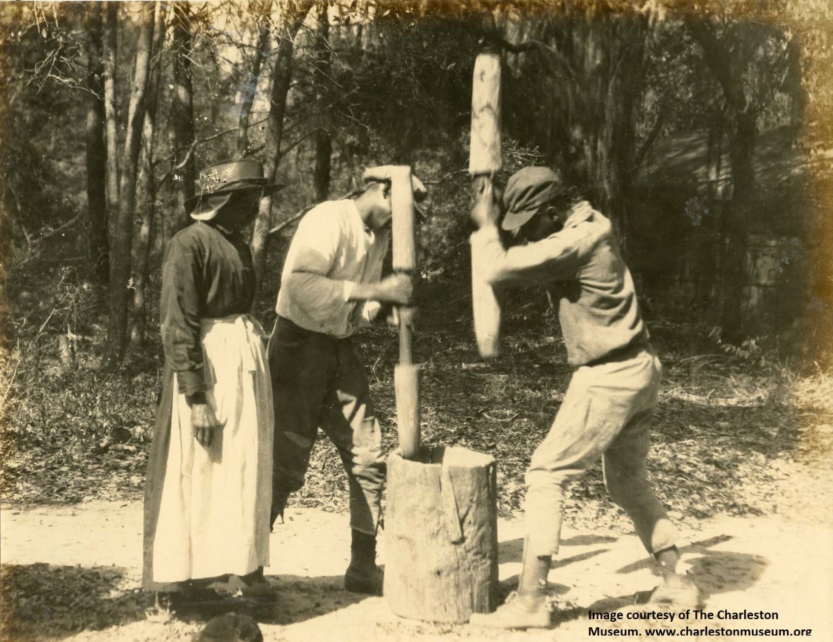 Demonstration of mortar and pestle to separate rice grains and hull